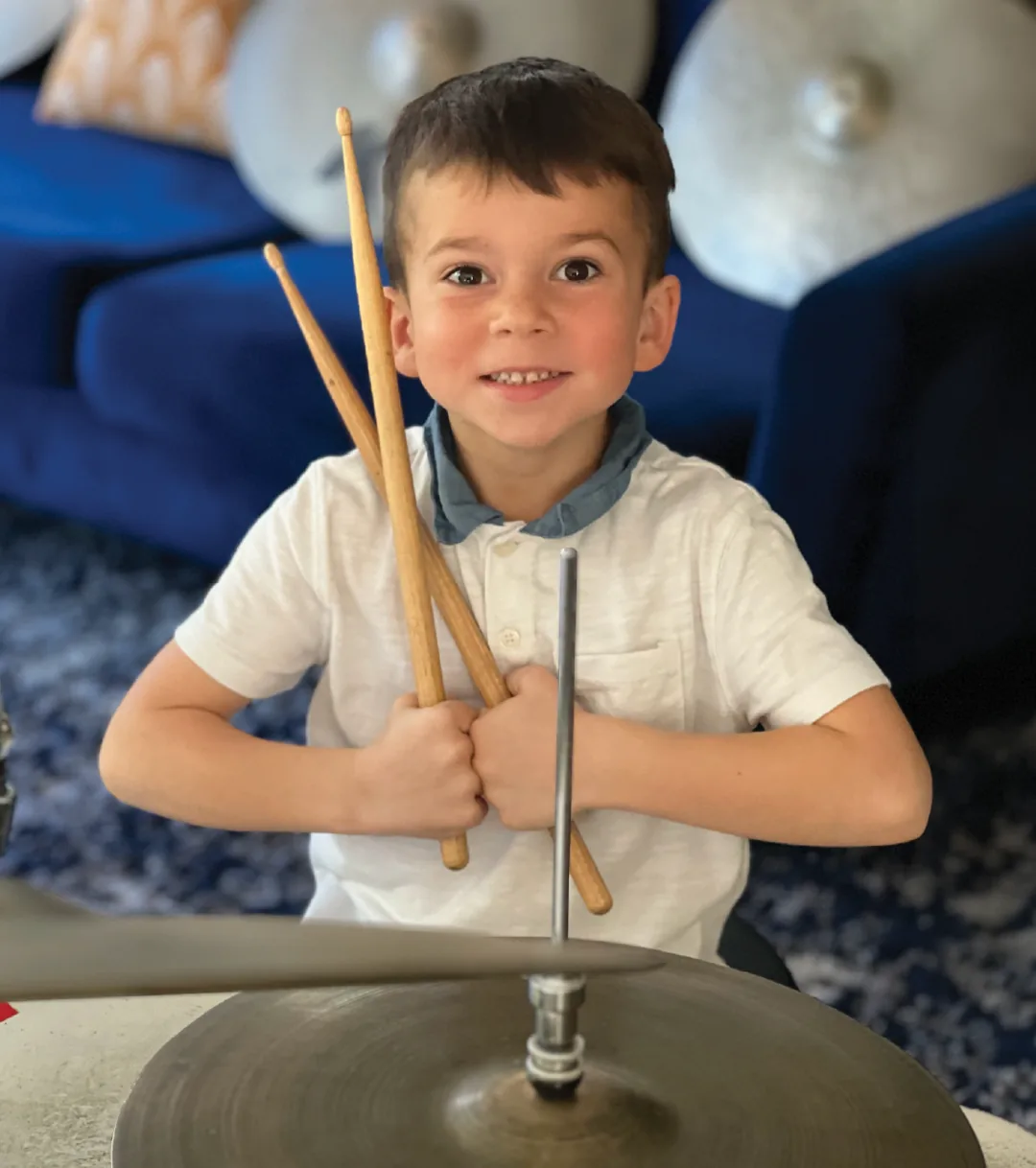 Young OC Drum Academy student holding drumsticks during a drum lesson in Tustin Young OC Drum Academy student holding drumsticks during a drum lesson in Tustin